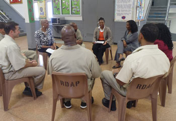 color photograph of prisoners in a group therapy session