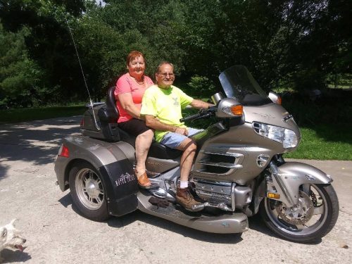 Picture for decorative purposes. Elderly couple on a motorcycle.