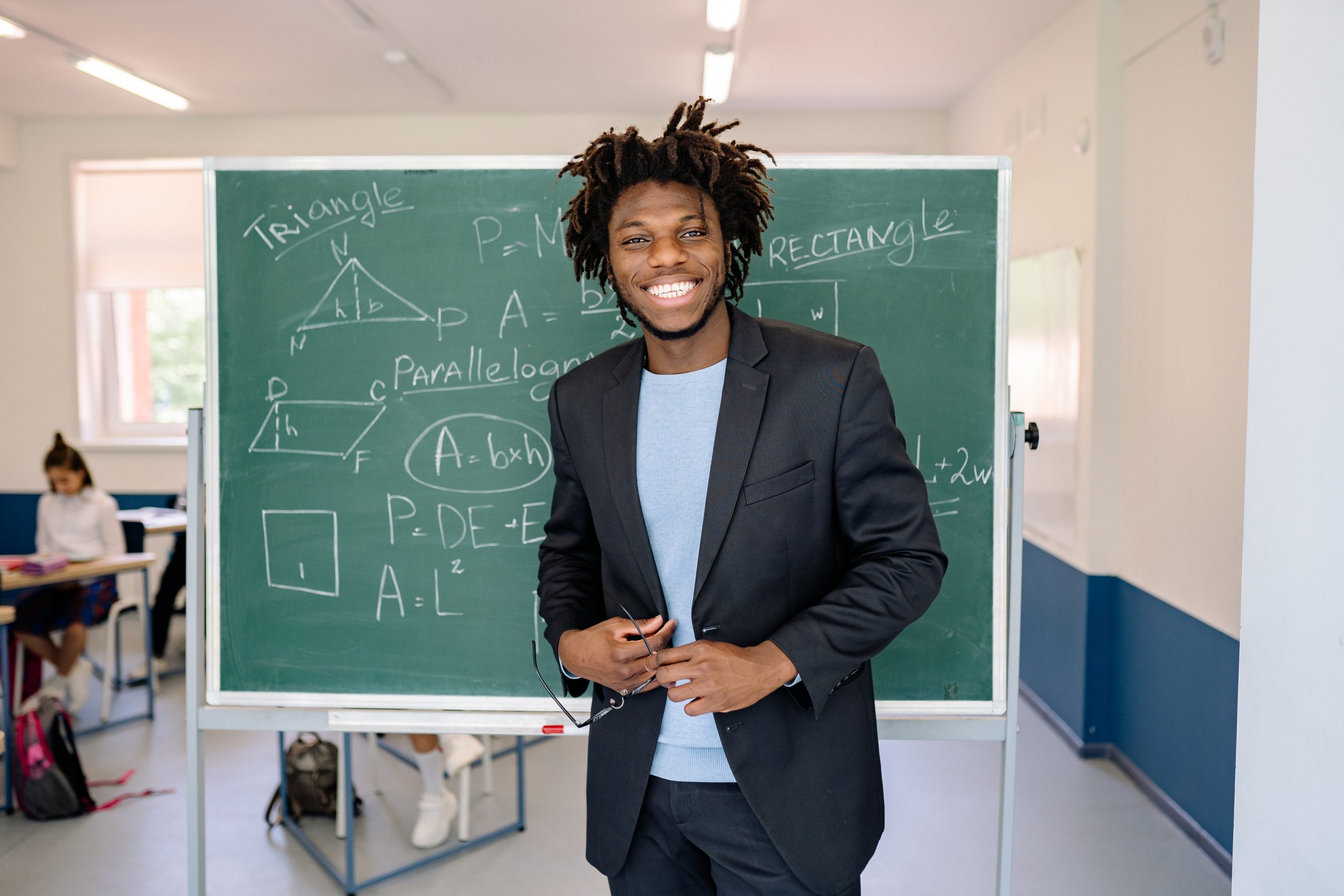 Black student in front of large chalkboard with geometric equations