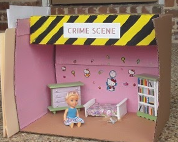 An image of a little crime scene with a doll in it.
