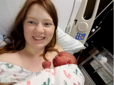 Image of the author holding her newborn son.
