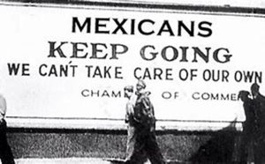 a 1930s image of a sign saying "Mexicans keep going"