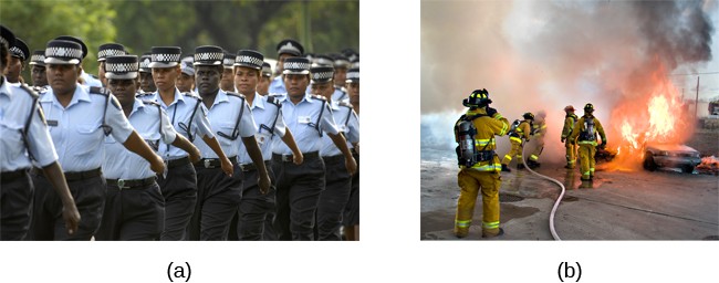 Photograph A shows uniformed police officers marching with synchronized arms swinging. Photograph B shows firefighters fighting a fire.