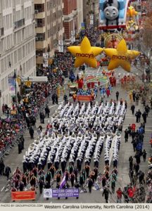 A series of groups and bands marching in a parade.