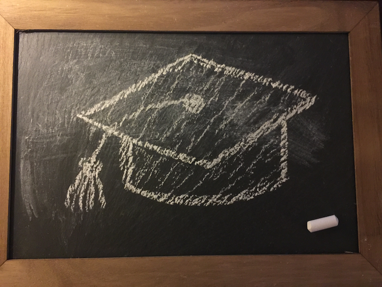 Slate with drawing of graduation cap