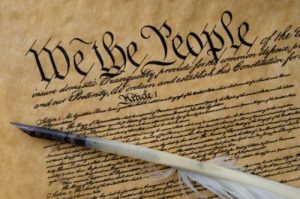 historical document in tight cursive with "We the People" at the top