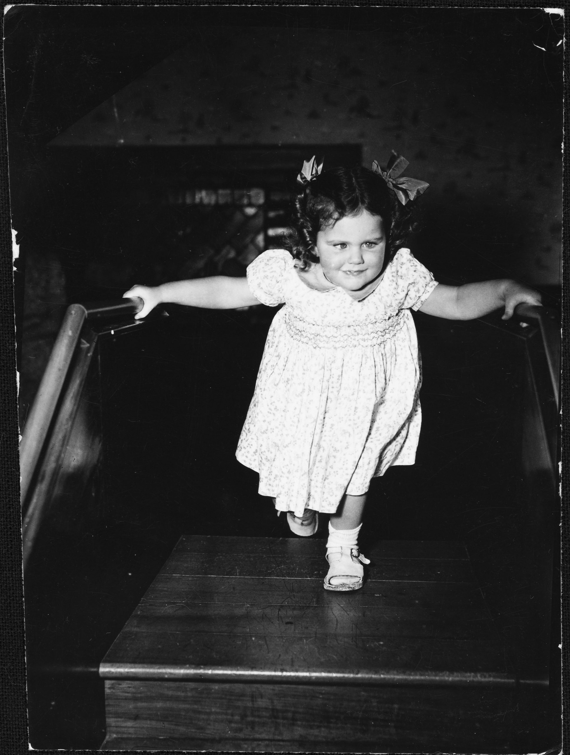 Lesley aged about four climbing the practice stairs in the play room at Sunrise home