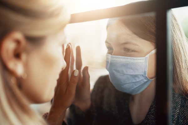 two women separated by class and masks