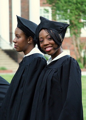 Two Black women in caps and gowns graduating from college