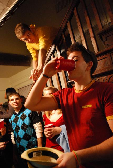 Young men at a party drinking from red solo cups
