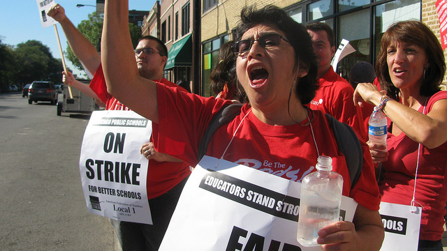 This photo of a labor strike depicts an example of the competition between two veto groups, labor and management, that characterizes American democracy. Pluralist theory assumes that veto groups win and lose equally in the long run and that no one group has more influence than another group.