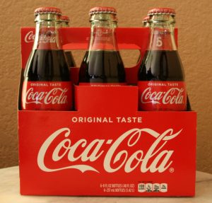 photograph of a container of bottles of Coca-Cola with the logo on the side