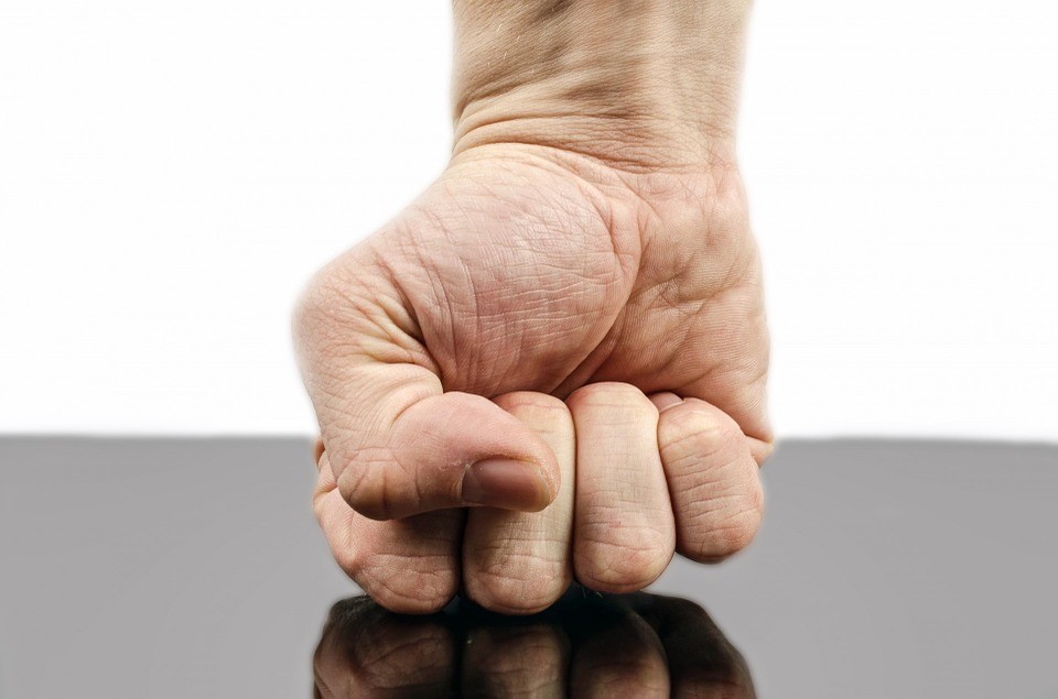 a fist striking a table