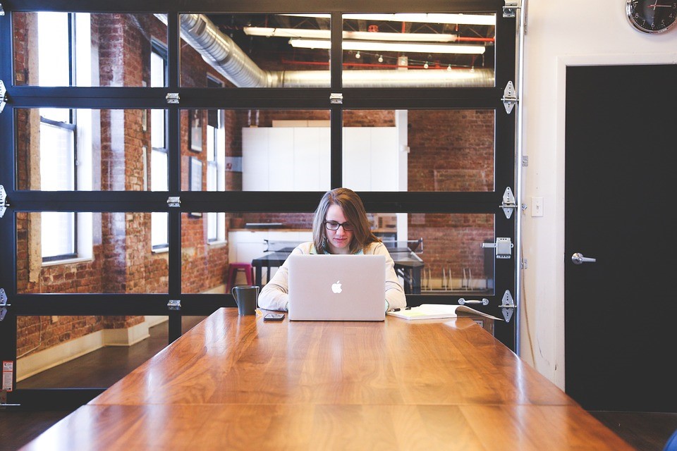 woman sitting at computer in a conference room