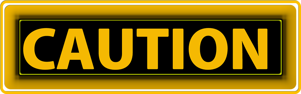 yellow sign reading caution