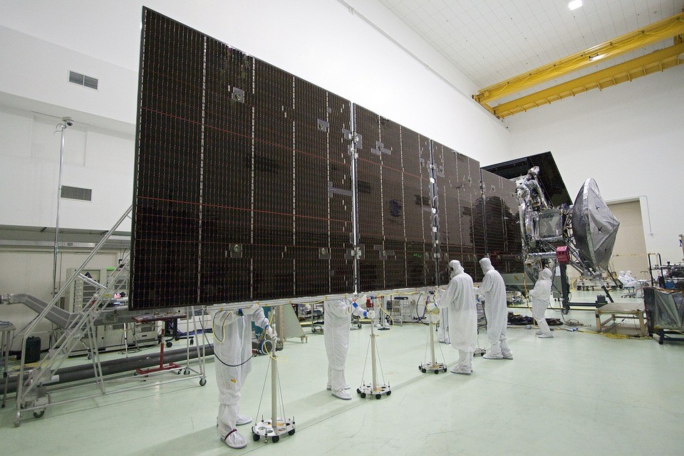 scientists working on a solar cell array in clean suits