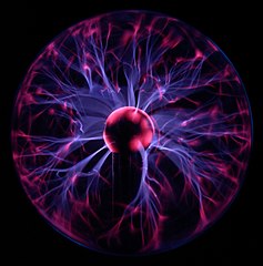 purple light radiates out from the center of a sphere in a plasma lamp