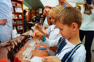 children with test tubes at a science event