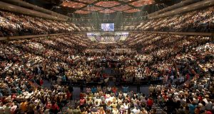A photo of thousands of people in a stadium during a megachurch ceremony