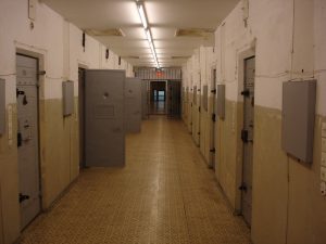 Figure (b) shows the hallway of a correctional facilty