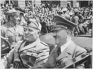 Adolf Hitler and Benito Mussolini are shown riding together in a car