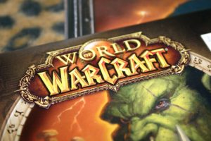 The cover of the video game World of Warcraft including a green, fanged ogre, is shown here
