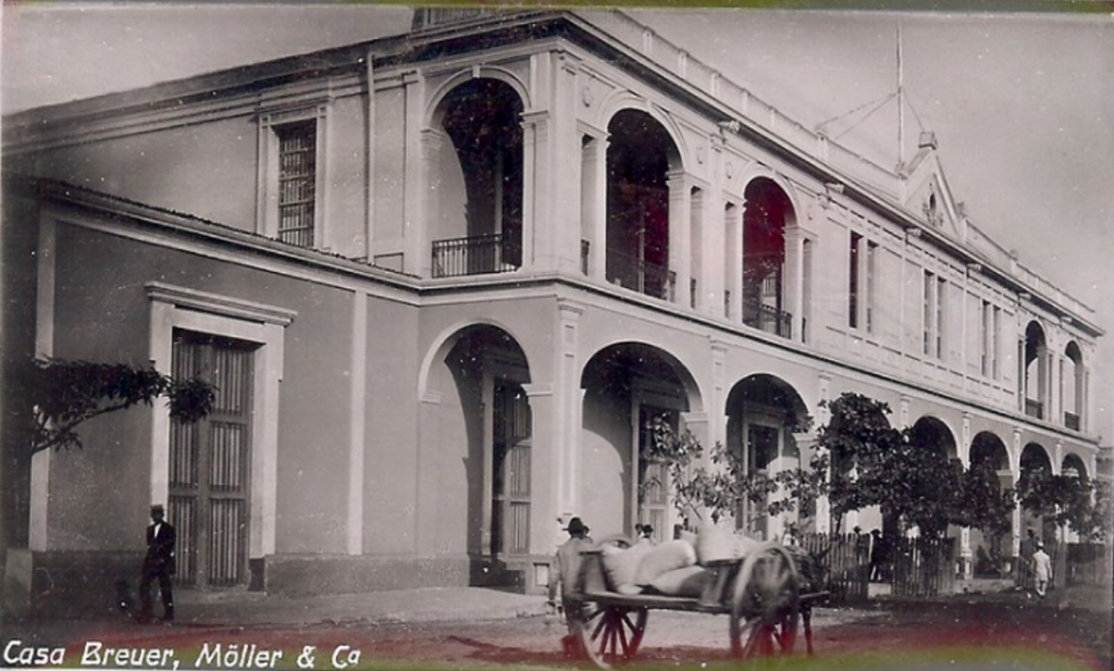 The two-storied offices of the merchant company of Breuer, Möller & Co, Maracaibo - with a donkey cart outside.