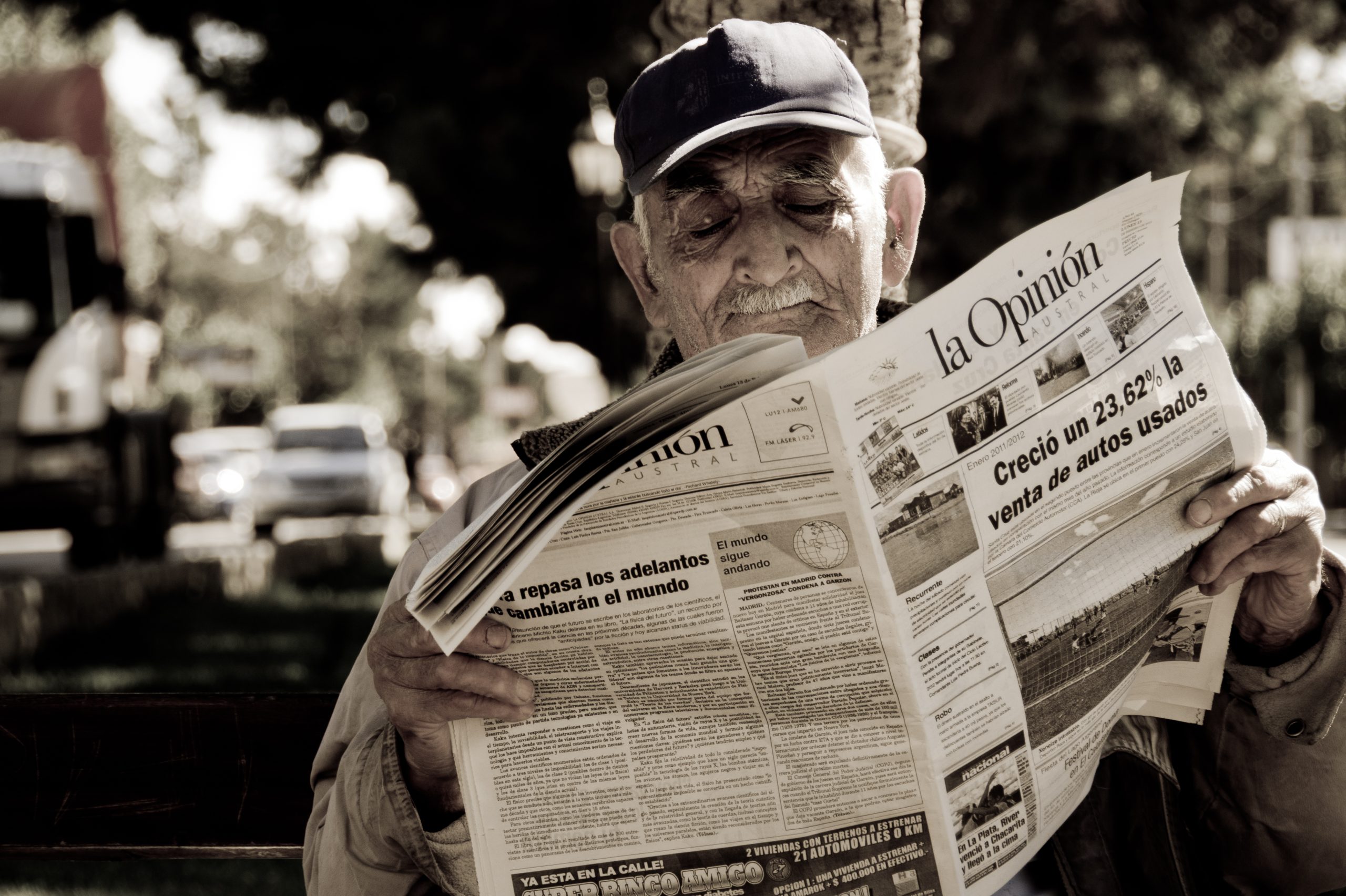 An old man reading a newspaper