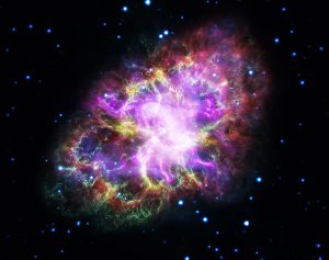 Multi-colored Crab Nebula surrounded by distant stars