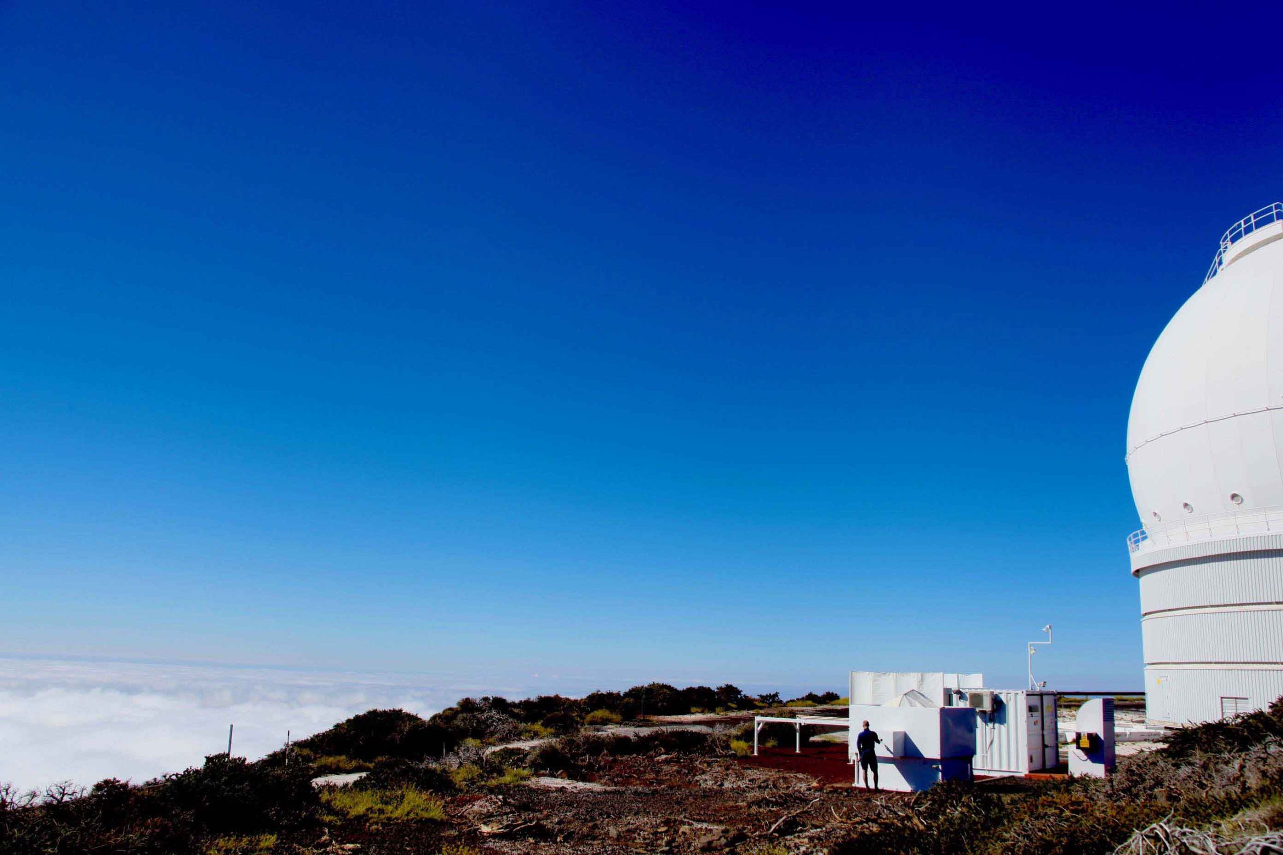 ​Blue sky with small human figure next to container​