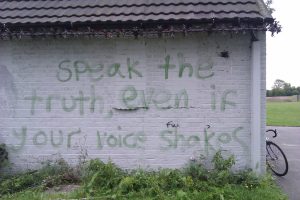 Graffito on building: Speak the Truth even if your voice shakes.