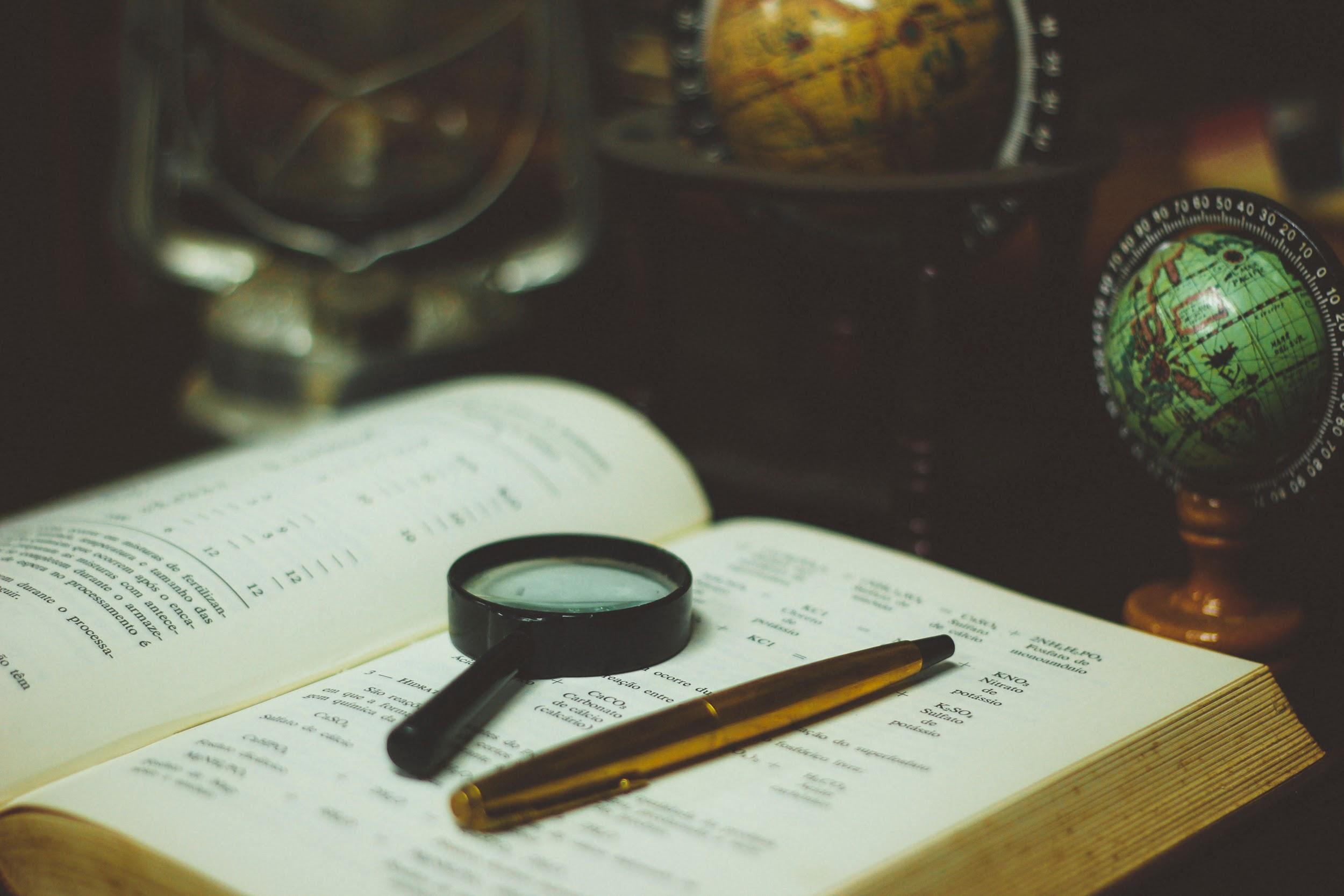 Globe, magnifying glass, and map book