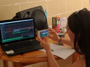 A student in a fieldschool videotapes her edits of an audio ethnography.