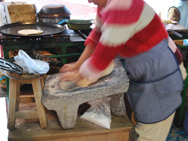 Image of Woman Grinding Corn with a Metate