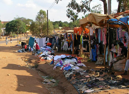 Image of a roadside stand in Zambia where used clothing is sold