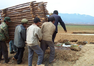 Na men carry a wooden structure to be used at a funeral