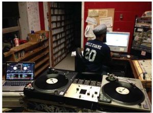 Harrison at work hosting an underground hip hop radio show.