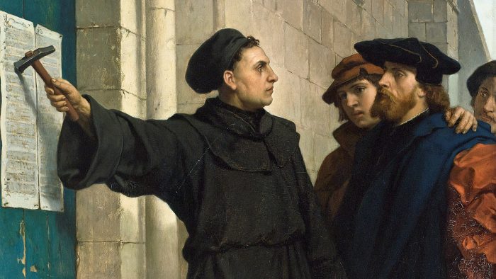Luther hammers his 95 theses to the door