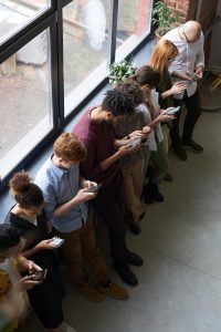 An image of several people on their smart phones.