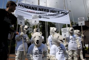Protesters dressed as polar bears fight climate poverty.