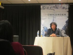 Snowpiercer director Bong Joon-ho speaking at a press conference.
