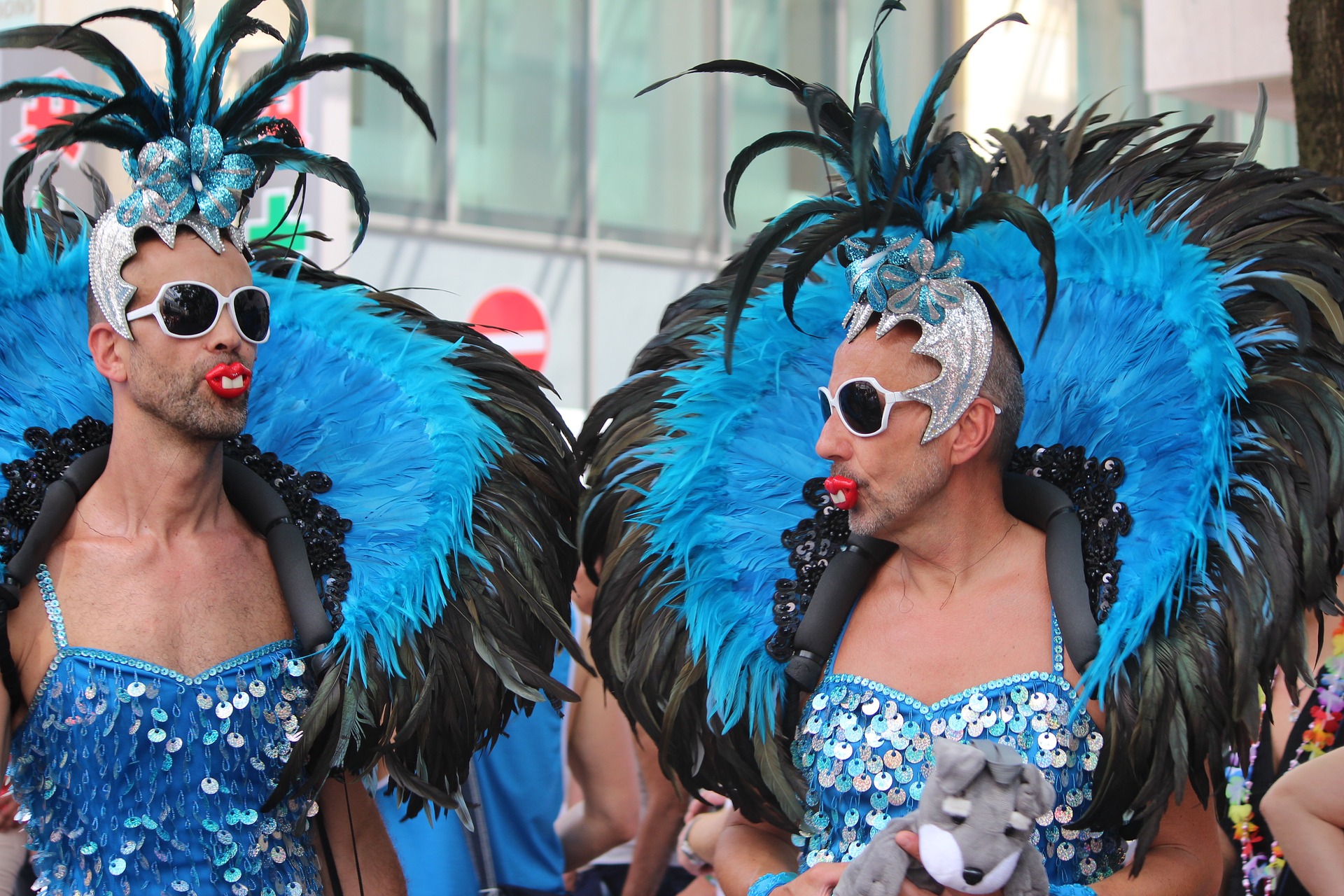 two guys in show girl costumes with bunny teeth (Karneval or Pride parade)