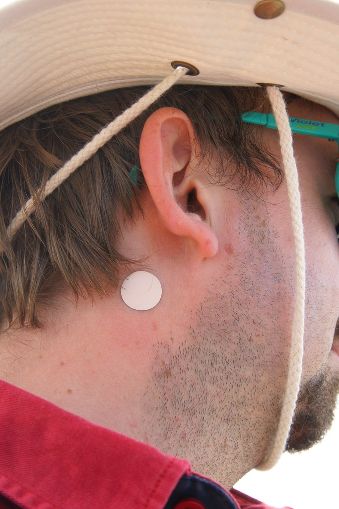 Photo of male with transdermal patch behind right ear