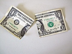 A U.S. one dollar bill torn in half.