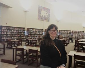 Lora Diaz standing in the library.
