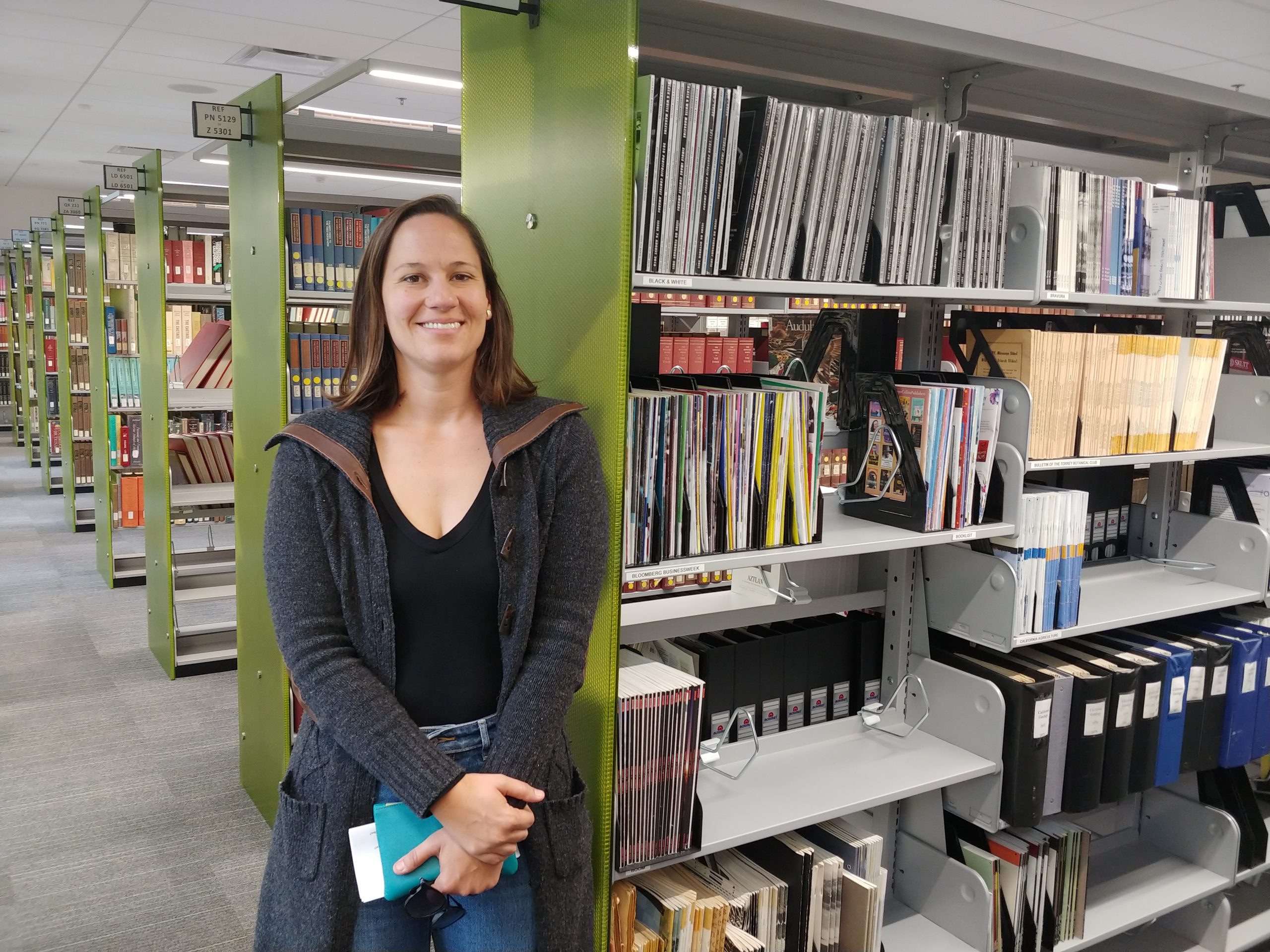 Rachel Schneider standing in a library.