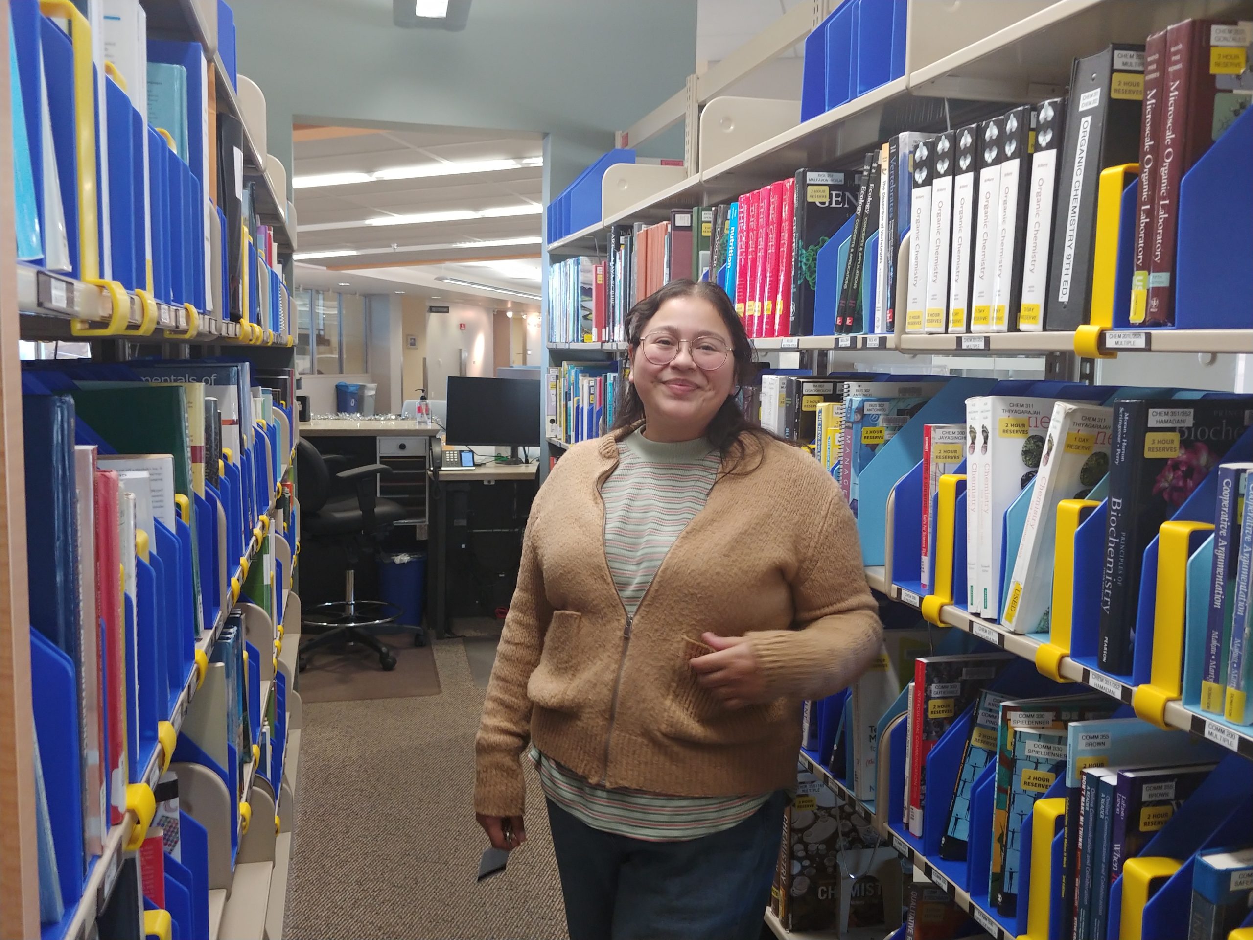 Alysa Hernandez standing in the reserve collection area.